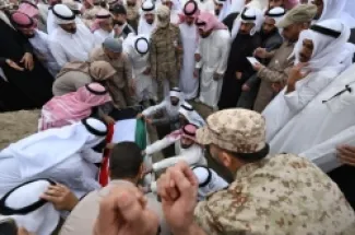 مشيعون يرفعون جثمان أحد أفراد الجيش الكويتي، الذي قُتل في غارة إيرانية على الكويت