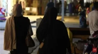 ثلاث سيدات عراقيات يمشين في  أحد شوارع بغداد